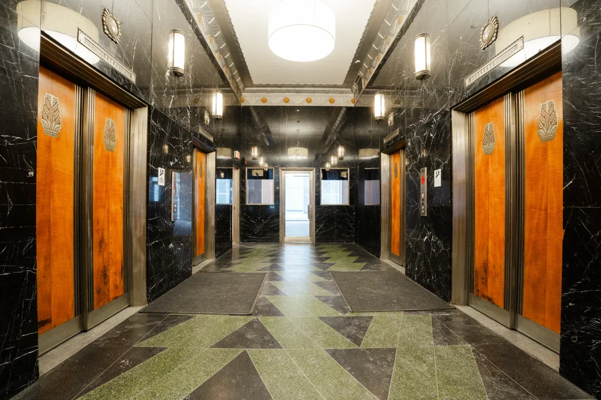 Original black marble and bronze elevator doors in the lobby